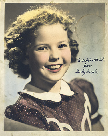 Studio portrait of Shirley Temple with handwritten inscription: To Andrew Worhola from Shirley Temple.