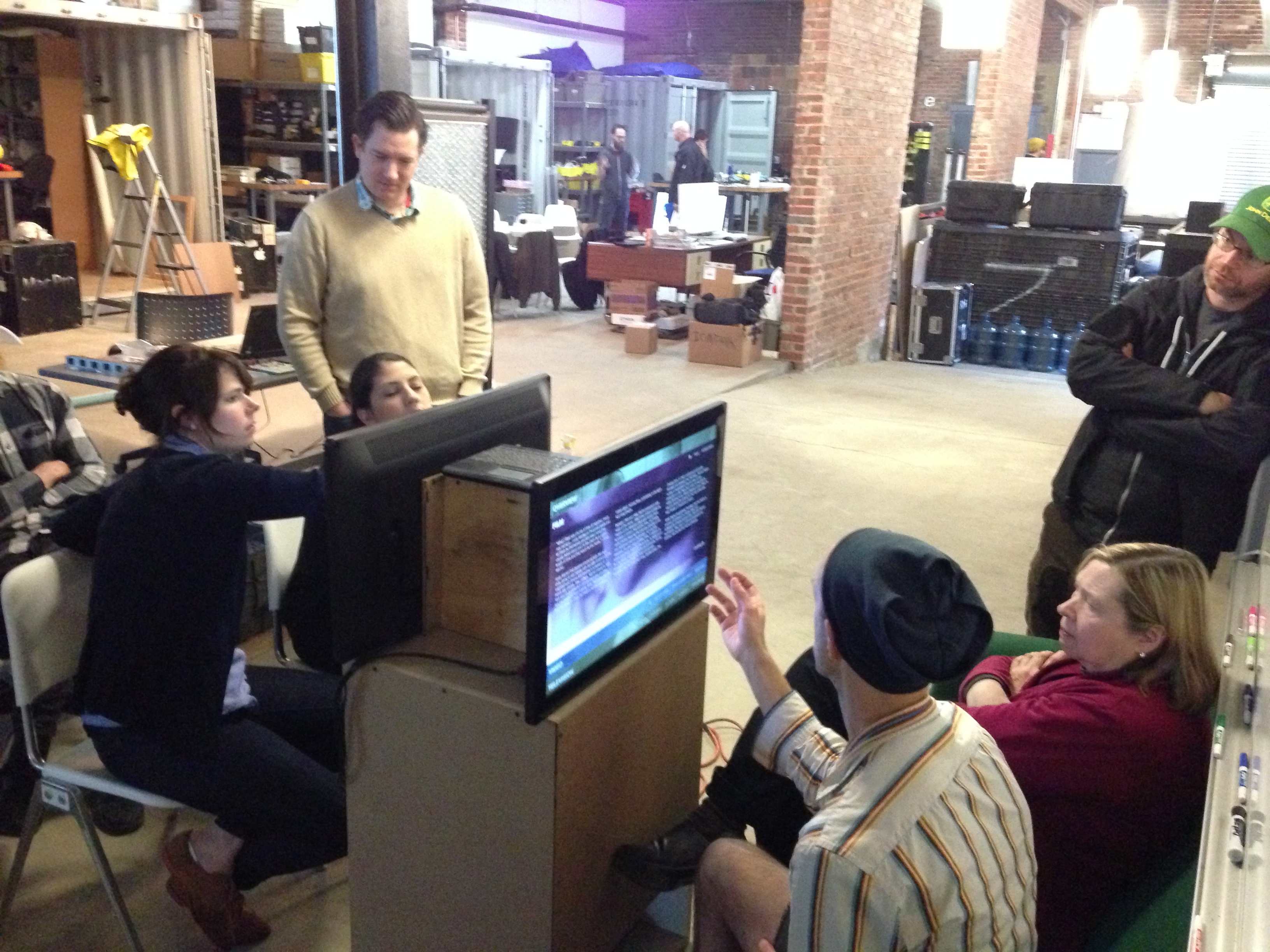Museum staff review a prototype of the interactive at IonTank's studio in Pittsburgh.