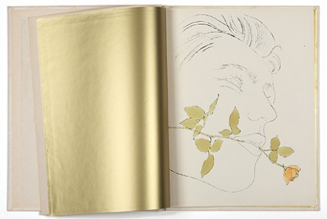 An open book showing a blank page that is gold colored and then a Warhol line drawing with gold accents on the facing page.