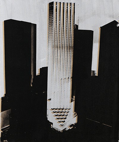 A black and white image of Trump Tower. It is the single white building, surrounded by the black silhouettes of other buildings against a pale sky.