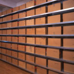 Warhol's Time Capsules, packaged in cardboard boxes and arranged on shelves.