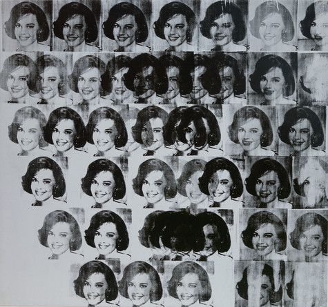 A screen print featuring rows of a repeated image of Natalie Wood in black ink. The headshots of the smiling actress overlap in some places, creating dark patches in the piece.
