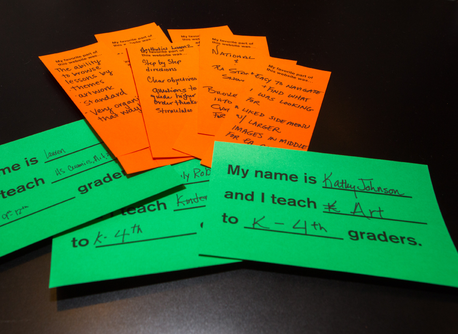 Completed comment and teacher information cards fanned out on a table