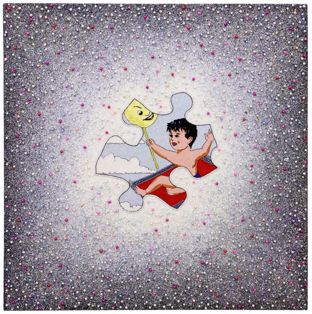 Hand embroidered multi-colored small beads on white canvas with a painted image in the middle, shaped like a puzzle piece. The painted image is of a boy with short, black hair riding on a red carpet with blue outline and holding a stick with a yellow balloon-like top that has a smiling face on it. The blue sky with some white clouds is in the background of the painted image.