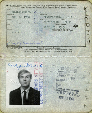 A passport opened vertically. The top portion is filled out with Andy Warhol's personal information and signature, and the bottom portion has a black and white photograph of Andy Warhol wearing a black suit and is stamped several times.