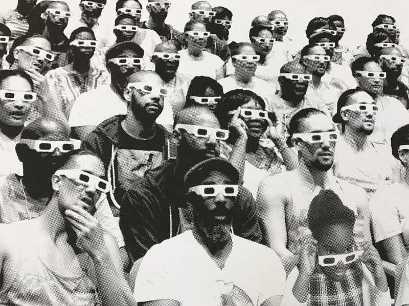 This is a black and white silkscreen print by artist Alisha Wormsley of an audience wearing 3D glasses.