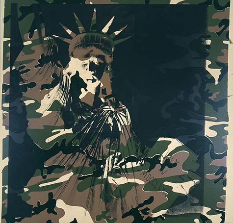 A screenprint by Andy Warhol of the statue of liberty on a camouflage canvas made up of greens and browns. The statue is in the camouflage colors while the outlines are in black paint.