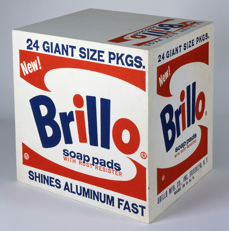 This artwork is a recreation of a cardboard Brillo soap pads box using silkscreen ink and house paint on plywood. The box is white with navy blue and red lettering. The blue caption on the front side top of the box reads 24 Giant Size Pkgs.”, while the bottom caption reads “Shines Aluminum Fast. In the middle of the box in red lettering is the word New!” with the brand name “Brillo” spelled out in alternating red and blue letters. Beneath that is the tagline “Soap Pads with Rust Resister”. The side of the box is similar except for a caption at the bottom printed in blue that reads “Brillo Mfg. Co. Inc. -- Brooklyn, N.Y. -- Made in U.S.A..