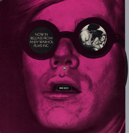 A film promotional card with a magenta photo of Andy Warhol's face with Now in Release from Andy Warhol Films Inc. in left eye. Film stills appear in right eye and correspond with film titles appearing in mouth as an internal disc is rotated.