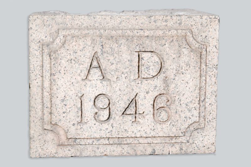 Side view of cornerstone with date that reads “AD 1946.”