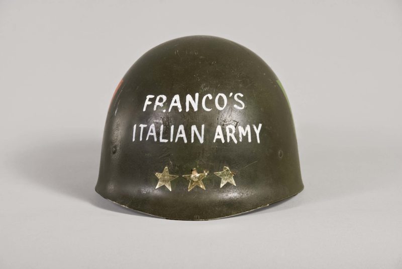 A metal helmet with “Franco’s Italian Army” and three painted-on stars.