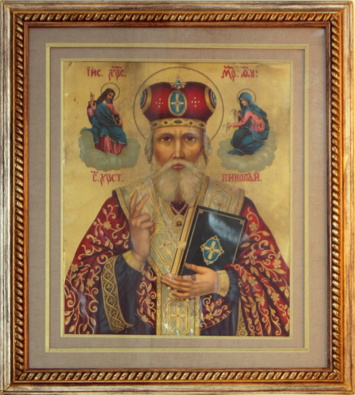 Framed, printed icon of Saint Nicholas of Myrna. Saint Nicholas is wearing luxurious red and blue robes and a gold crown. Next to his head are images of Jesus and Mary rested on clouds.
