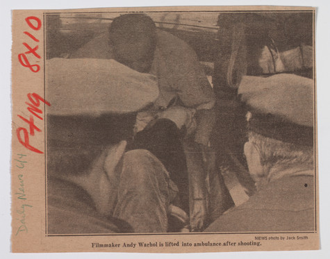 A newspaper clipping from The New York Daily News dated June 4th, 1968 showing Andy Warhol being lifted into an ambulance after being shot. This clipping shows Warhol’s handwritten notes in the left margin; Daily News 6/4 in green and Ptng 8x10 in red.