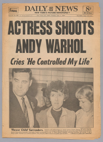 The New York Daily News newspaper with a headline that reads Actress Shoots Andy Warhol / Cries 'He Controlled My Life'. There is a photo of a detective and police woman with another woman (Valerie Solanas) in the middle.