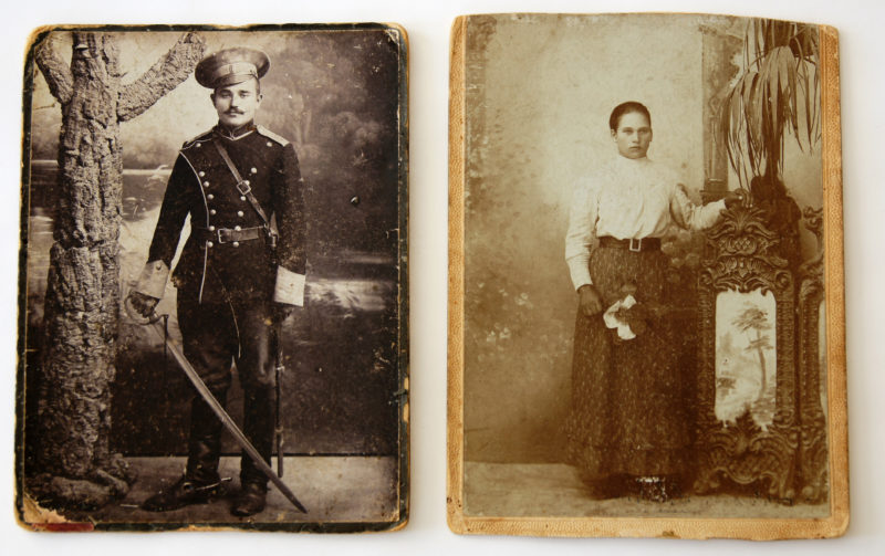 Two black and white photos, matted on a firm backing. The photo on the left features a man in a military uniform with a sword, while the photo on the right features a woman posed in dress clothes.