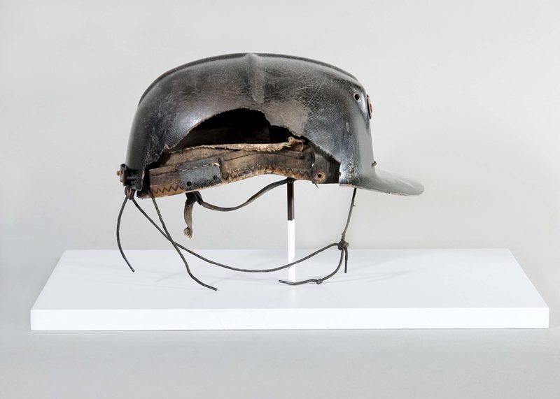 Front view of metal miner’s helmet.