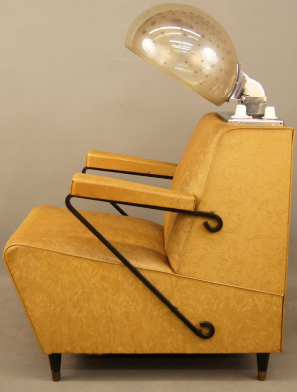 Side view of salon chair with attached dryer. The chair is marigold and has a floral pattern.