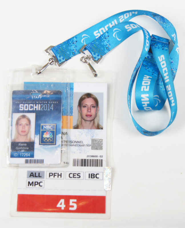 Front view of two identification cards with a woman’s photo, attached to lanyards.