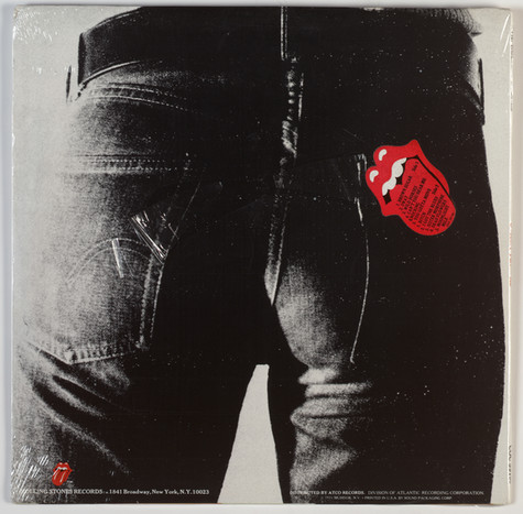 The back cover of the Rolling Stones' album Sticky Fingers featuring a close-cropped rear view of a man in jeans. On the right back pocket is the Rolling Stones' logo, which is a cartoon drawing of a mouth with the tongue sticking out.