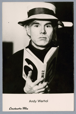 A postcard with a picture of Andy Warhol wearing a sunhat and holding a copy of his book a: a novel.