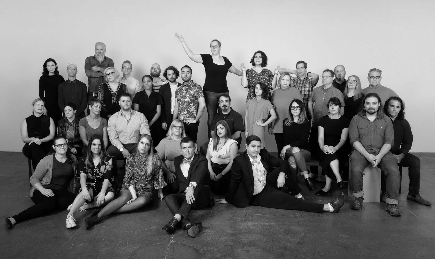 Black and white photo of a large group of people together posing for the camera.