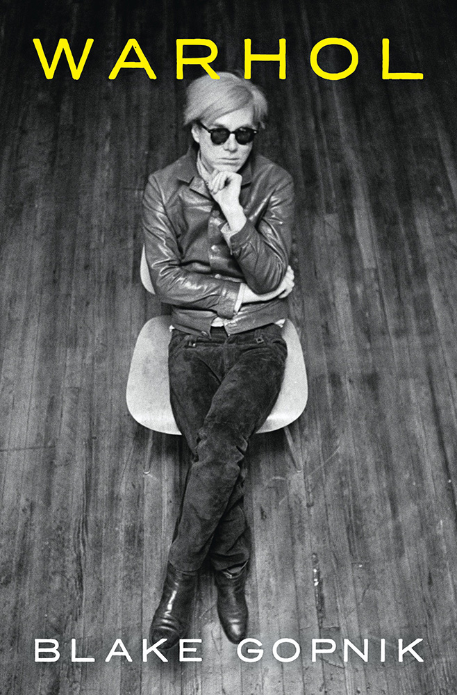 A book cover with a black and white photograph of a person sitting on a chair. The text on the cover says "Warhol" "Blake Gopnik"