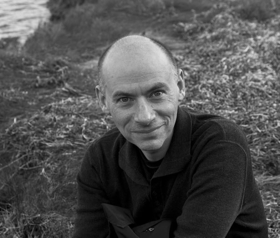 Man in portrait against wooded backdrop