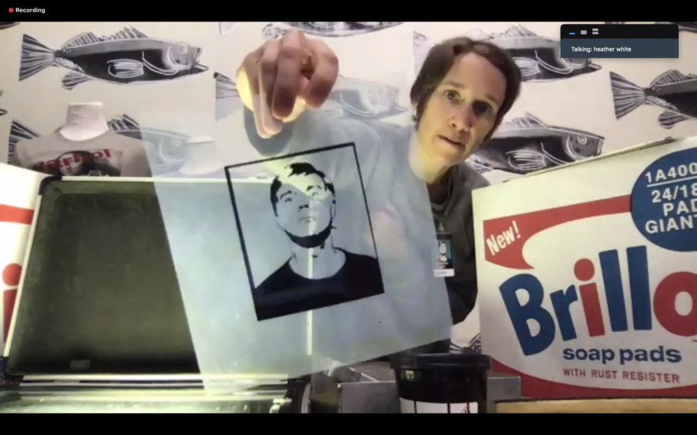 Museum educator holding up an acetate of Andy Warhol