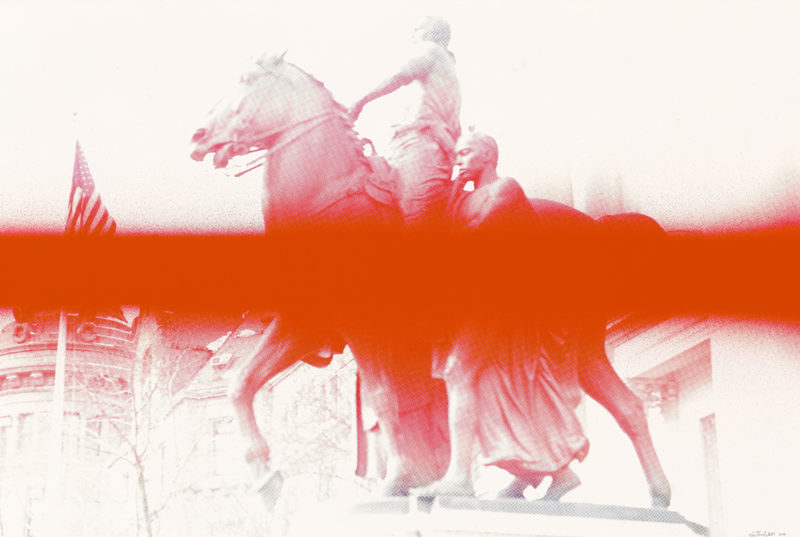 A red line going across the picture of a statue depicting a man riding a horse with another man standing next to it.