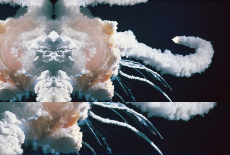 Against a black background, smoke trails stream toward the right from a larger, rounder cloud of smoke on the left. A partial, horizontally-mirrored copy of the image extends the left-side of the image, and an enlarged section of the image extends the bottom.