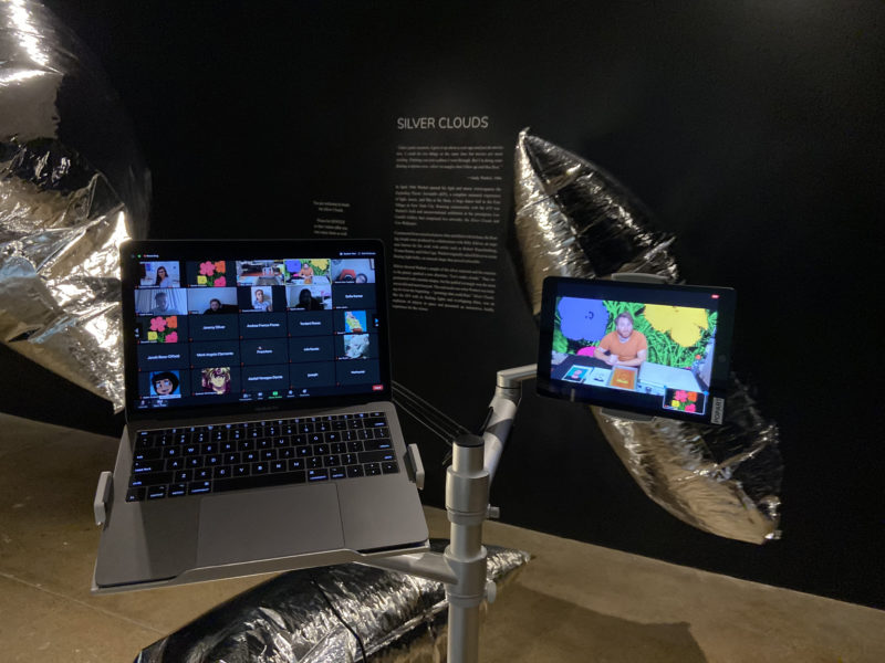 A laptop and iPad displaying a virtual learning experience in the Silver Clouds gallery
