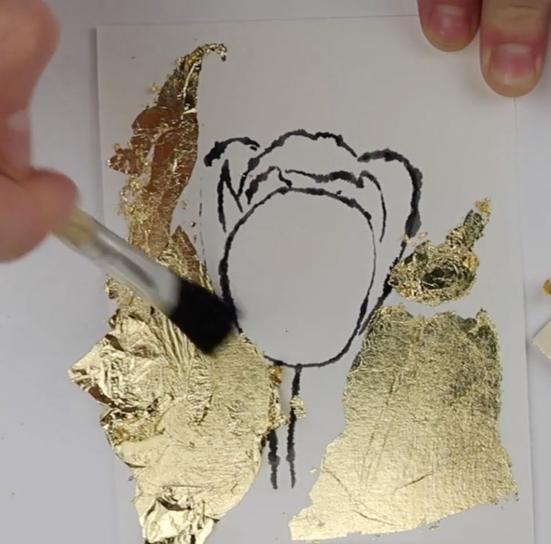 Hands shown demonstrating how to use gold leafing material.