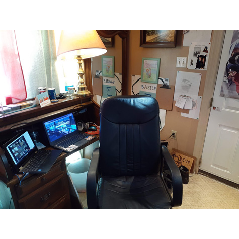 Computer desk chair, in front of two monitors