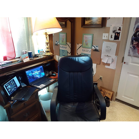 Computer desk chair, in front of two monitors