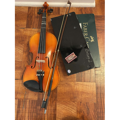 A violin and bow on top of an art portfolio