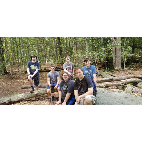 Photo of six people in the woods