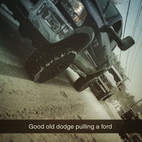 Image of a Dodge truck pulling a Ford truck