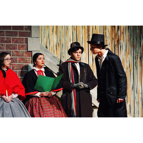 Four people on a stage acting out a play