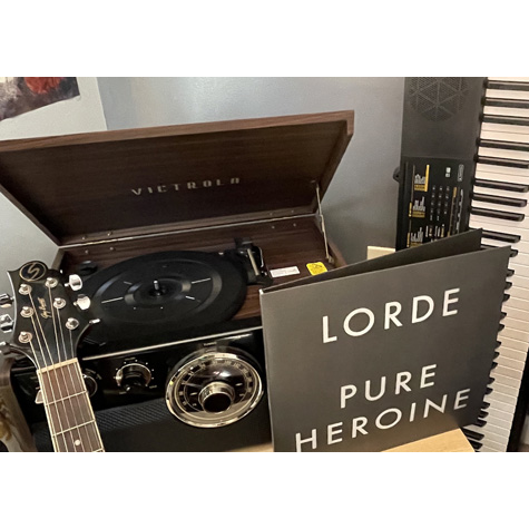 A record player with a record titled Lorde Pure Heroine