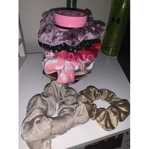 Various scrunchies on a bed side table