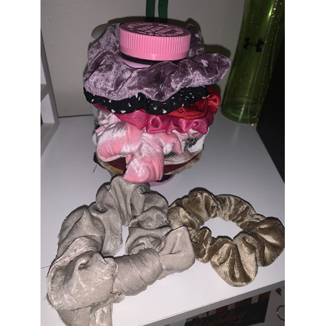 Various scrunchies on a bed side table