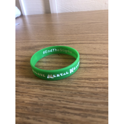 A green bracelet that says end the stigma