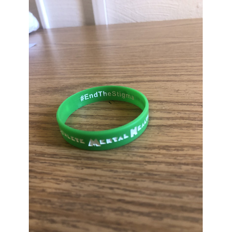 A green bracelet that says end the stigma