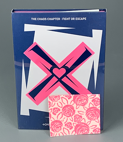 An album cover with a pink X and roses