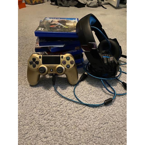 stack of video games and headphones