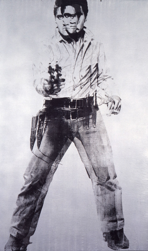 Two black and white images of Elvis holding a handgun superimposed over each other with a slight horizontal offset.