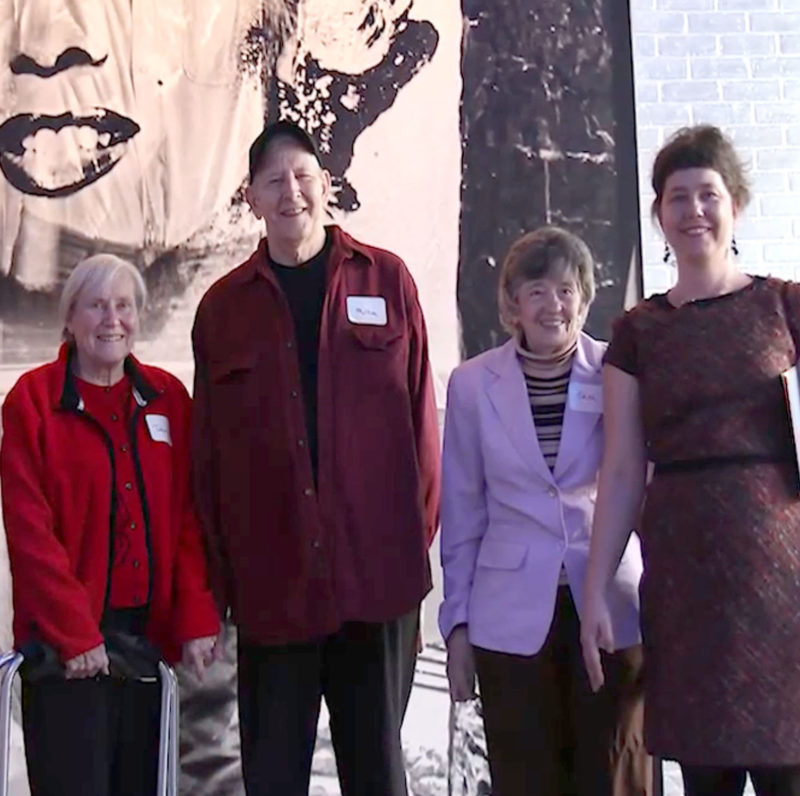 A group of people standing in front of a Warhol artwork