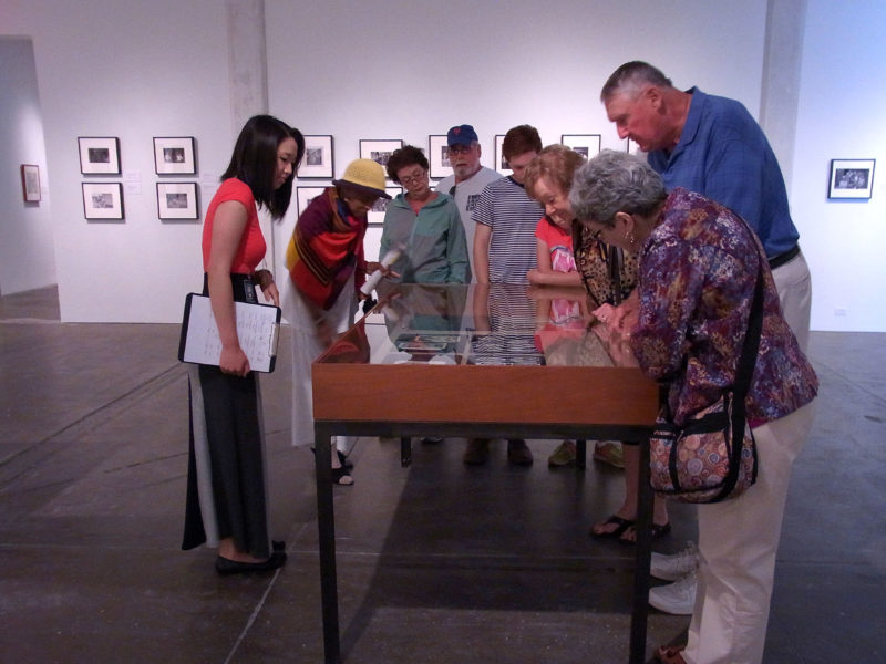 A group of people looking into a vitrine