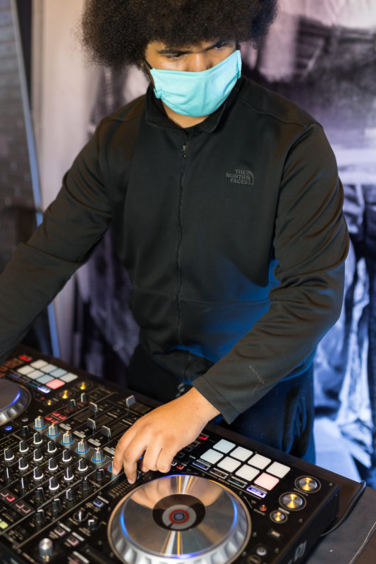 DJ playing music on a turntable.