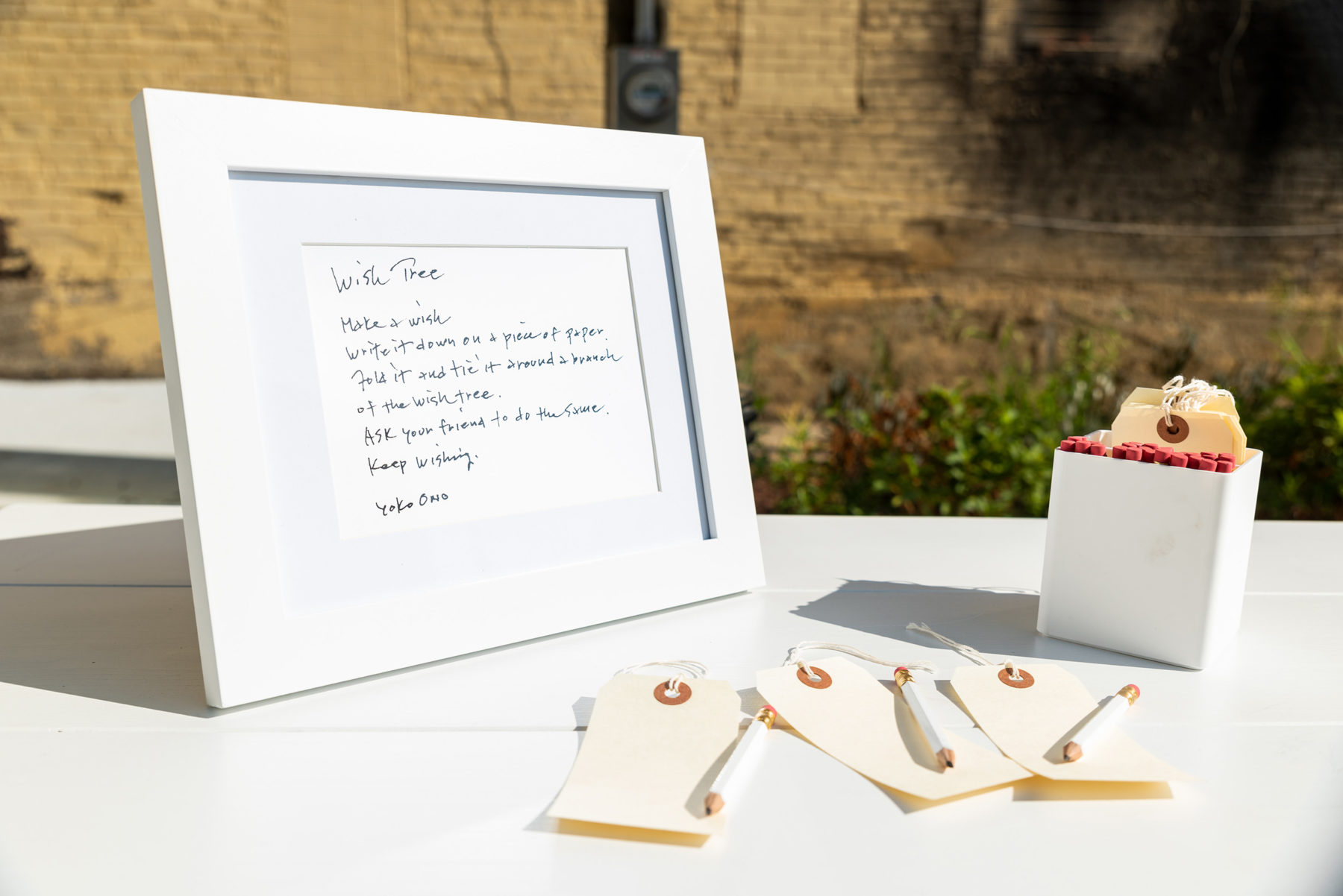 Table with instructions, paper tags, and pencils.